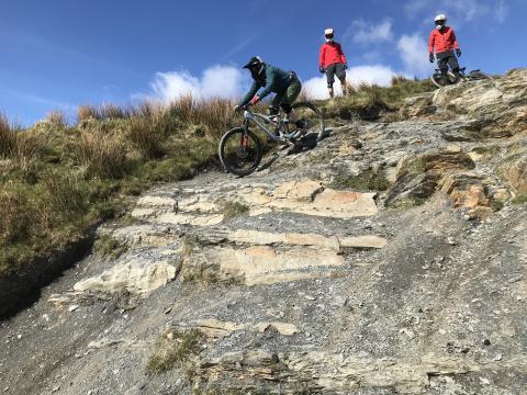 Stu tackles a rocky section on the black run while Jon and Gwyn offer advice